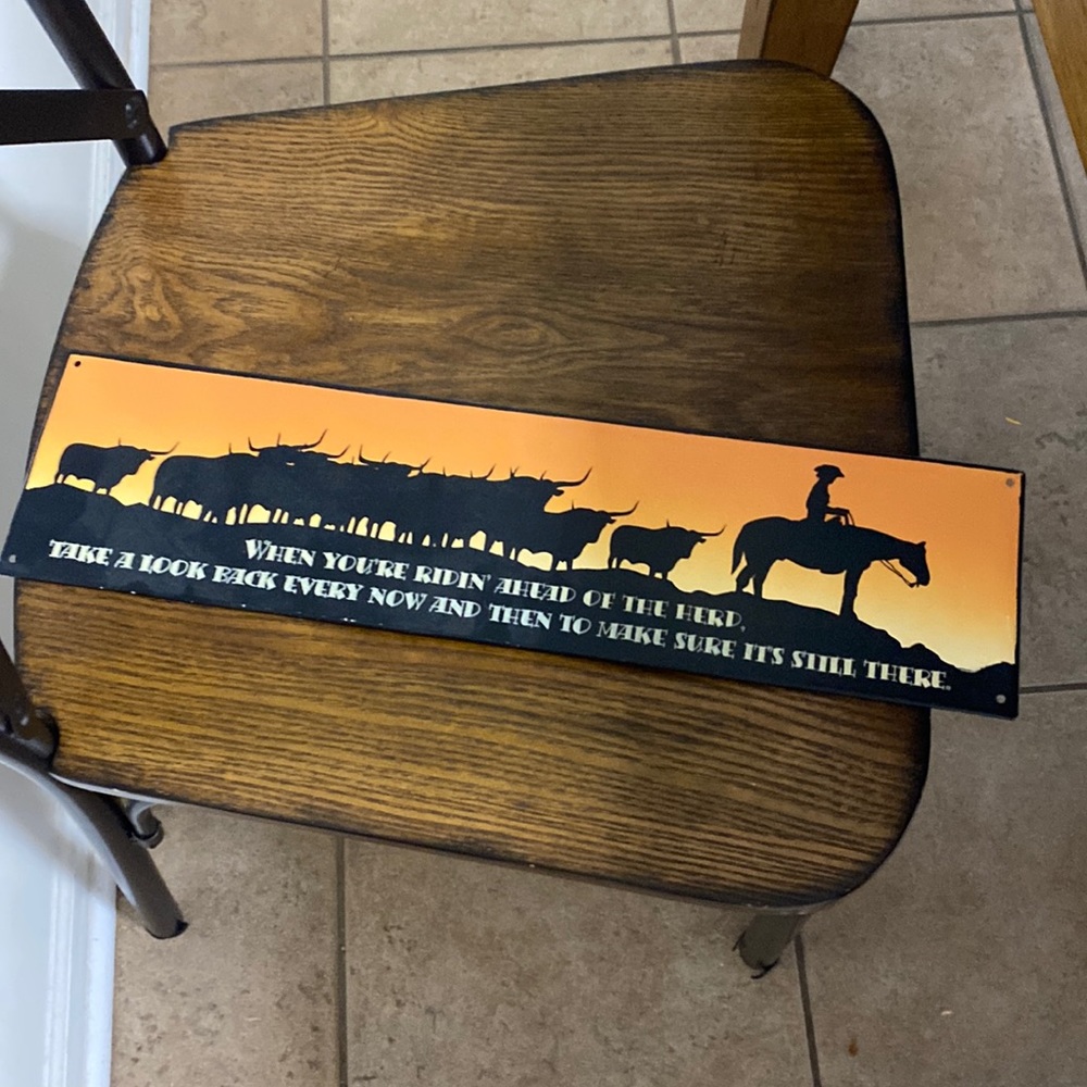 Cowboy with Heard Metal sign